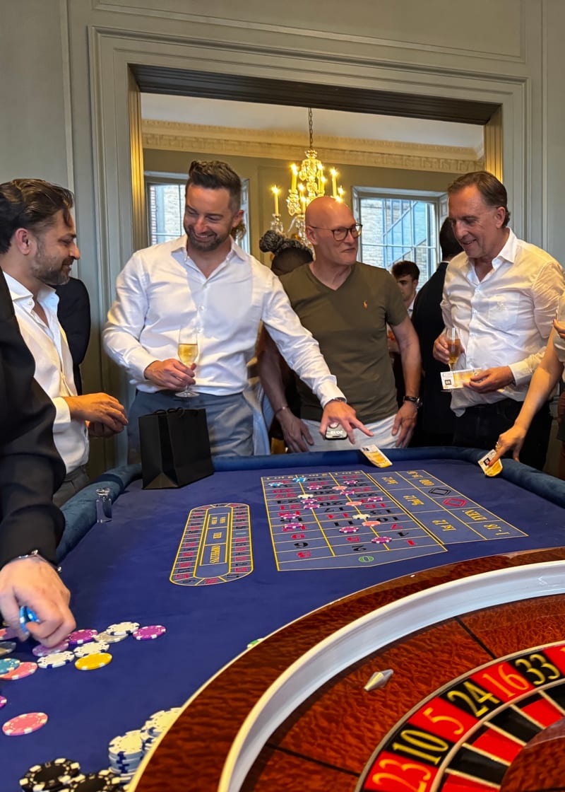 Wedding casino hire in London: guests around a roulette table at a country-house reception