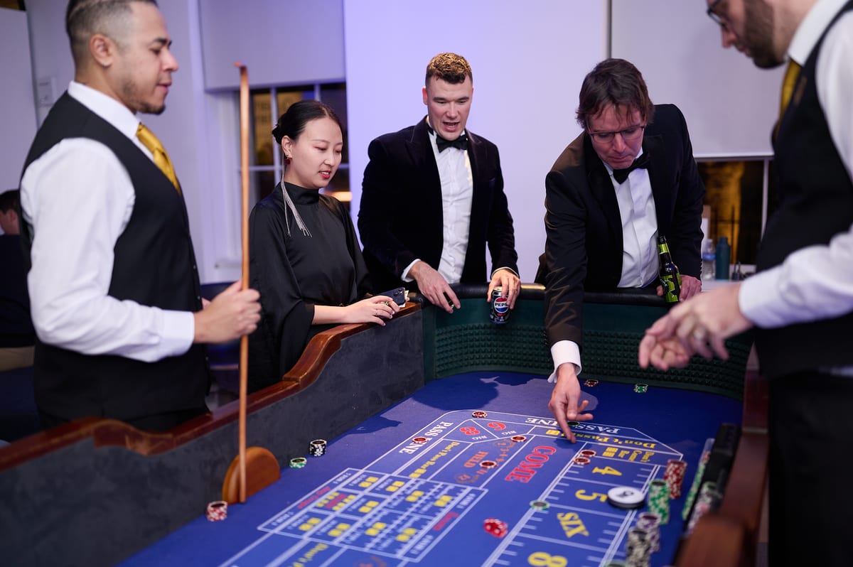 Our croupiers running the craps table as a guest places a bet