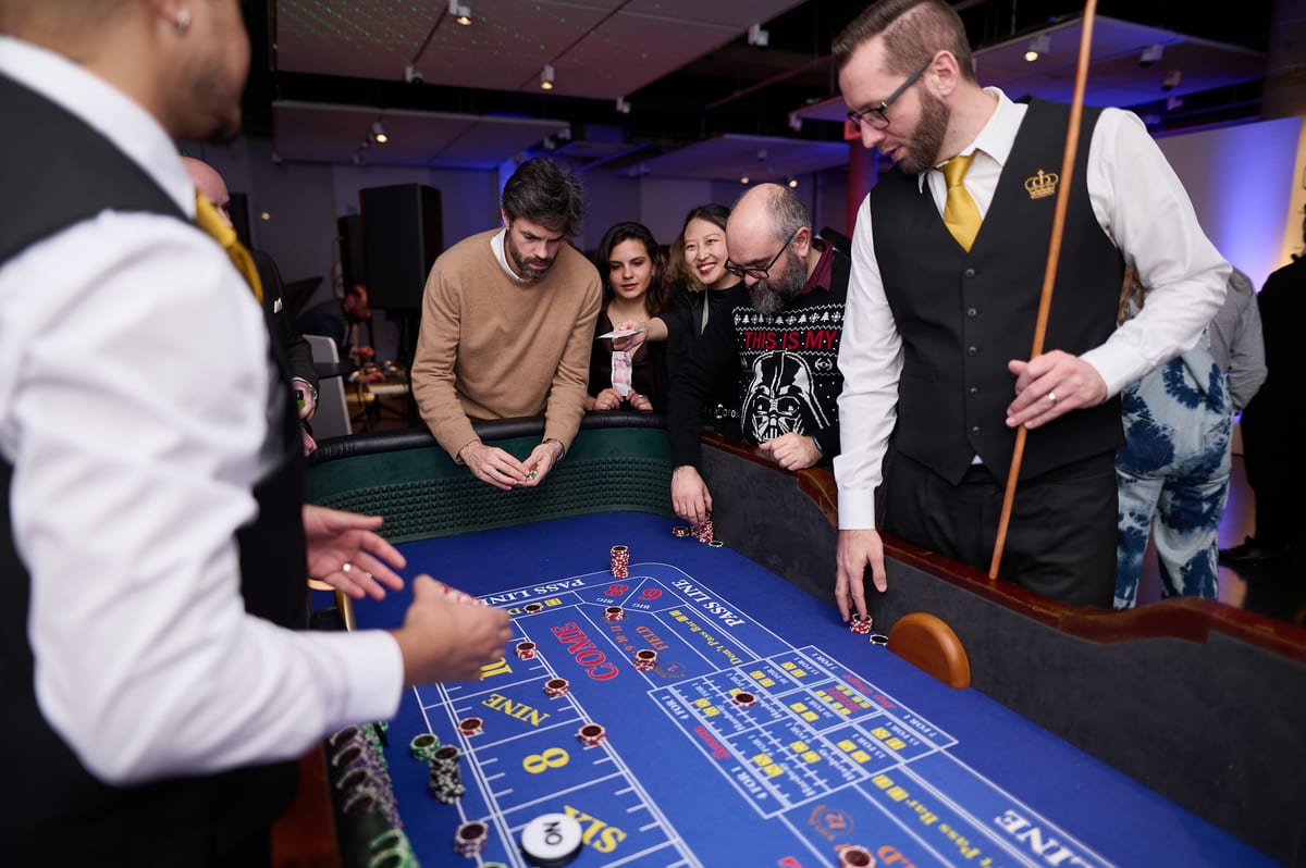 Guests lined up along the craps rail with our stickman