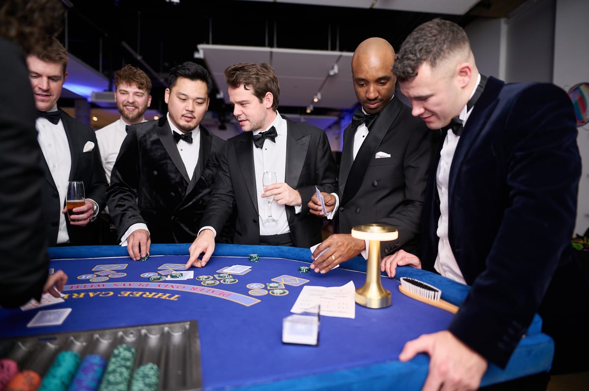 Guests in black tie playing Three Card Poker