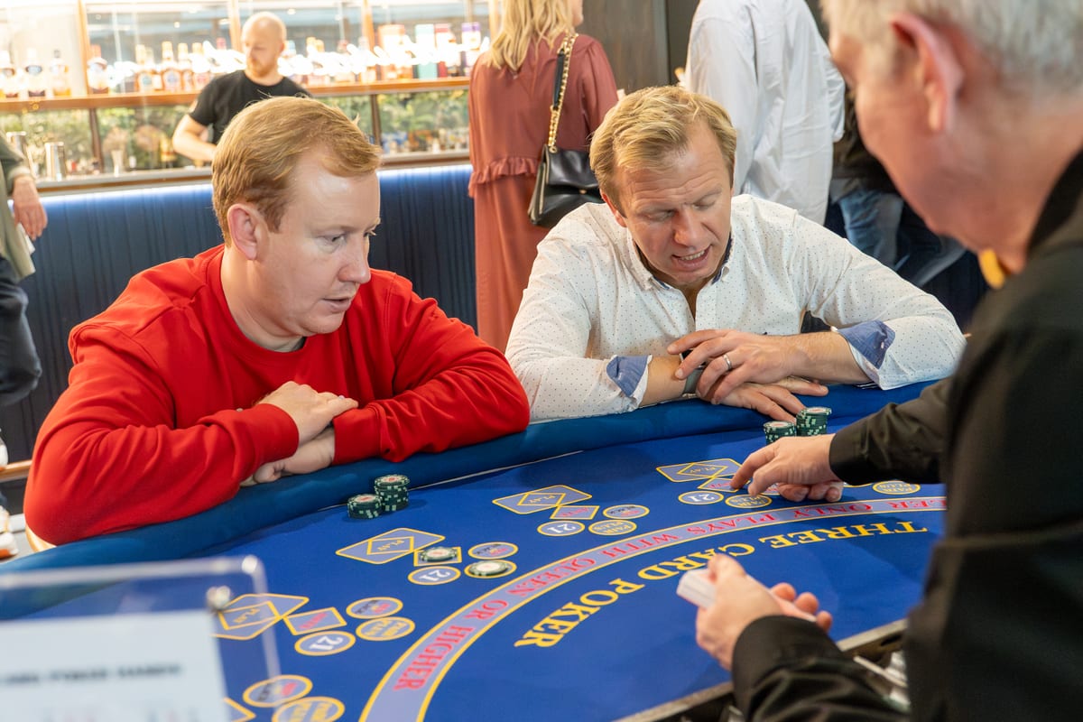 A guest checking a Three Card Poker hand