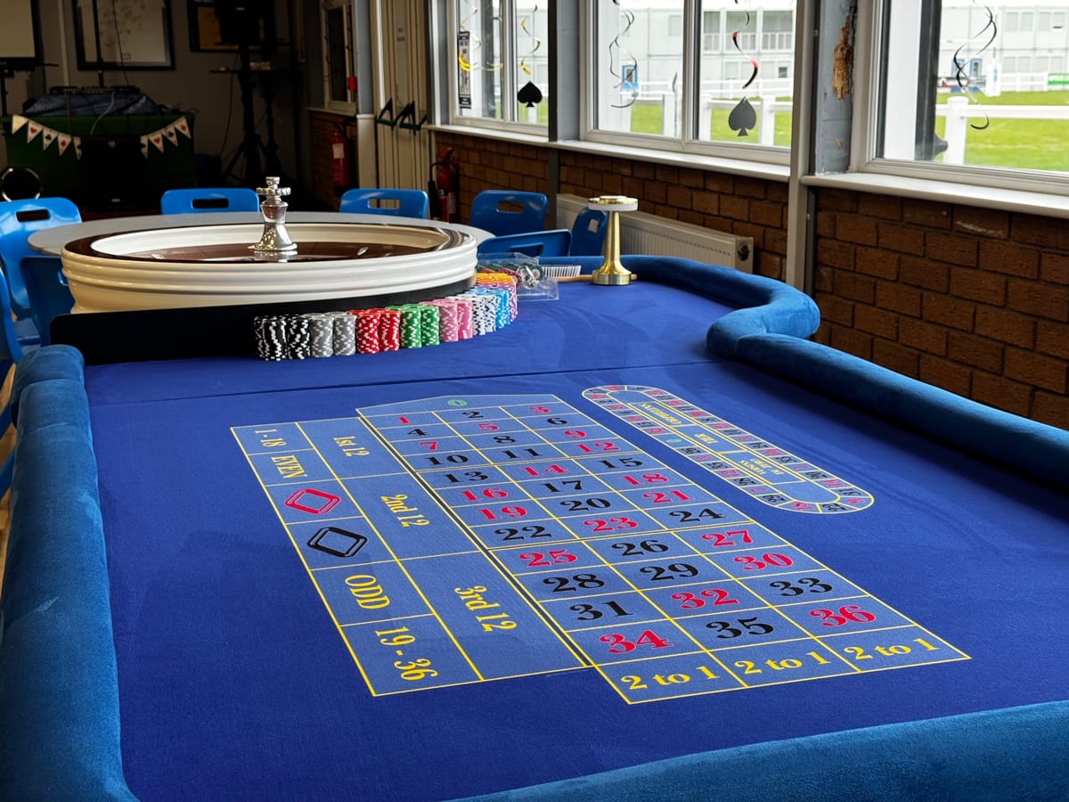 A roulette table set up by the windows of a racecourse suite