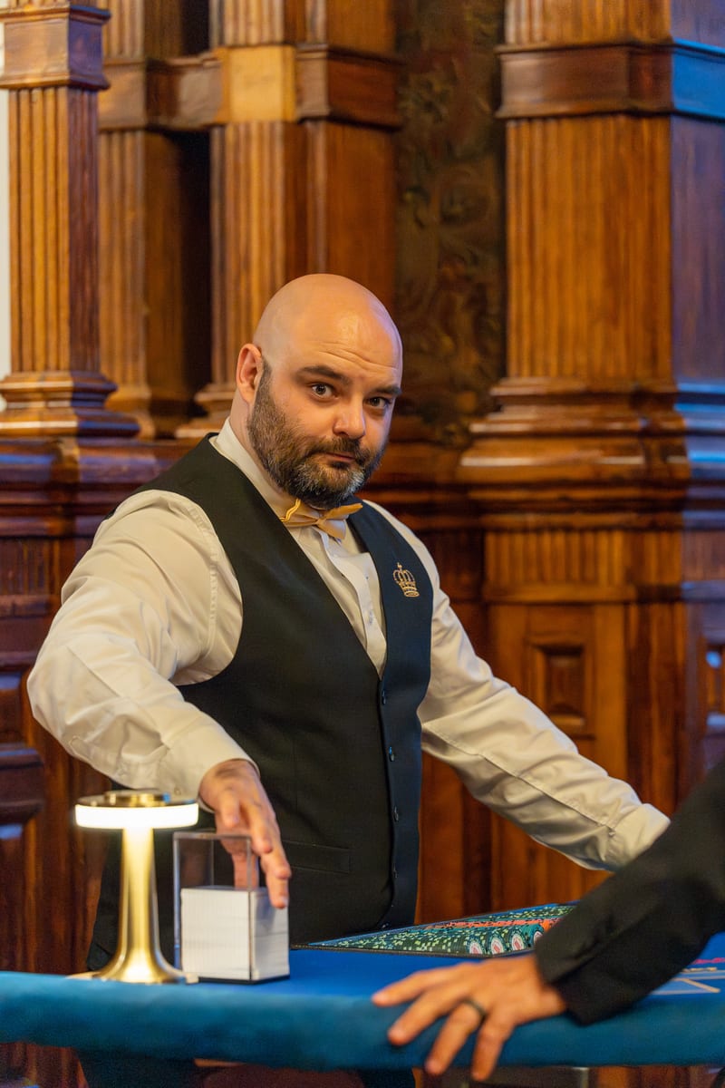 One of our croupiers at the table in an oak-panelled hall