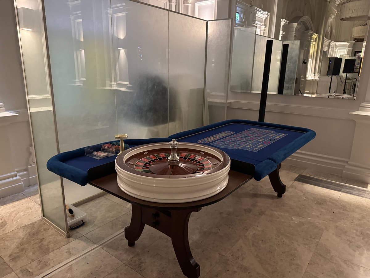 A roulette table set up in a glass-walled room