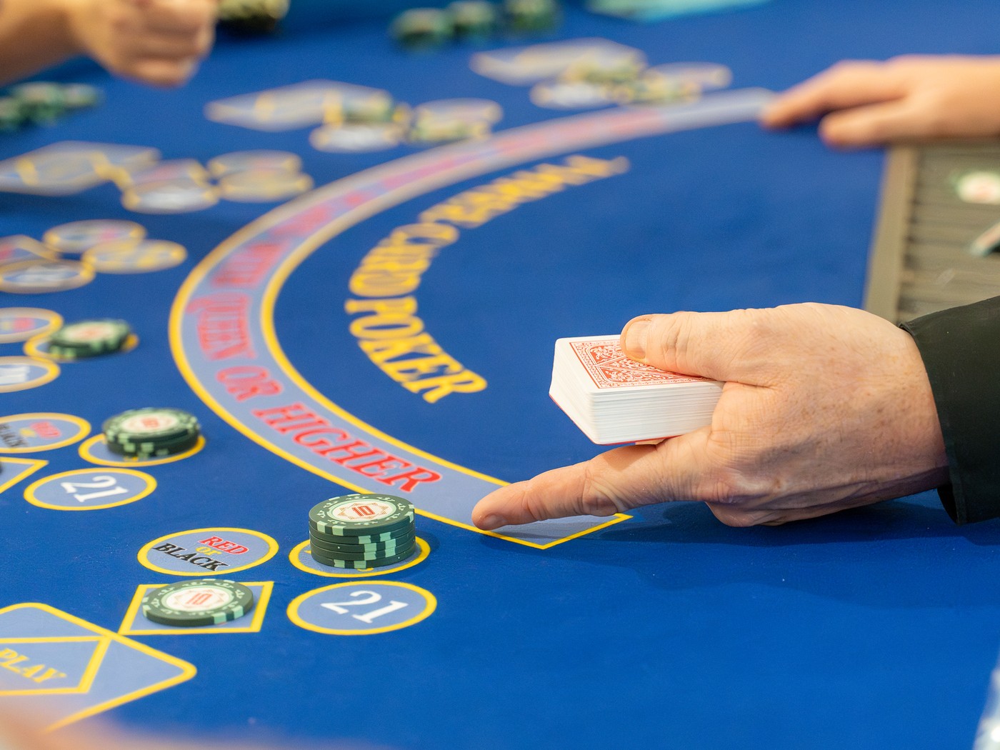 Three Card Poker table with chips and cards in play