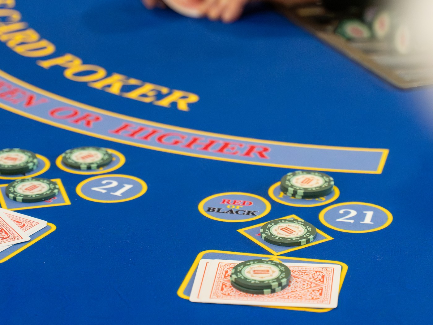 Three Card Poker layout with chips on the side bets