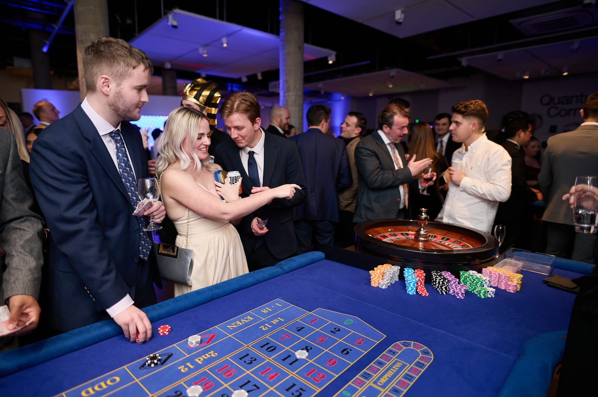 Guests placing chips on the roulette layout at a corporate party