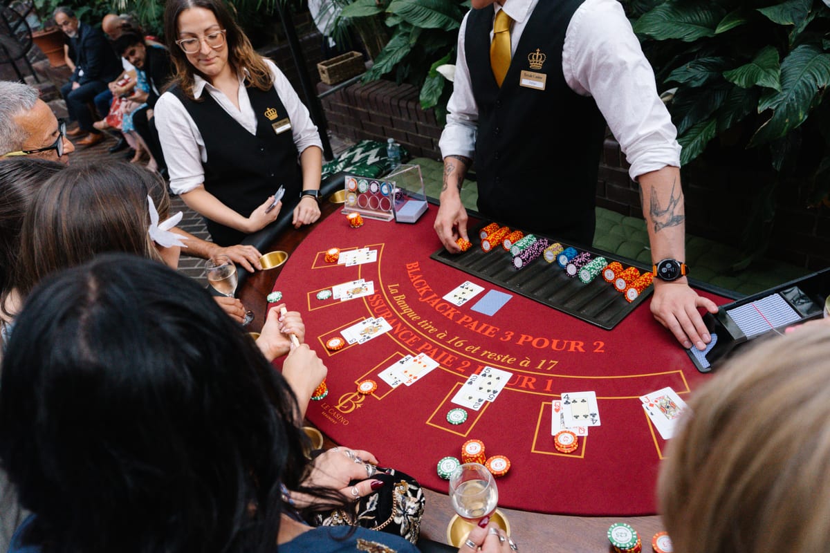 Two of our croupiers running a red blackjack table in a garden conservatory