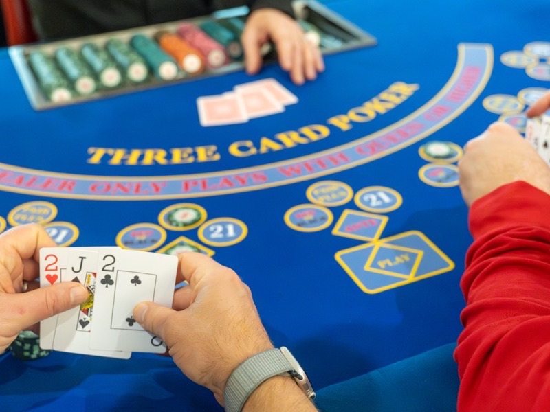 A three card poker table laid out for guests