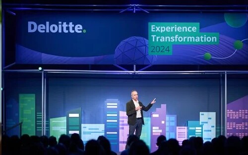 A keynote on stage at a Deloitte corporate event, photographed by Event Photographer London